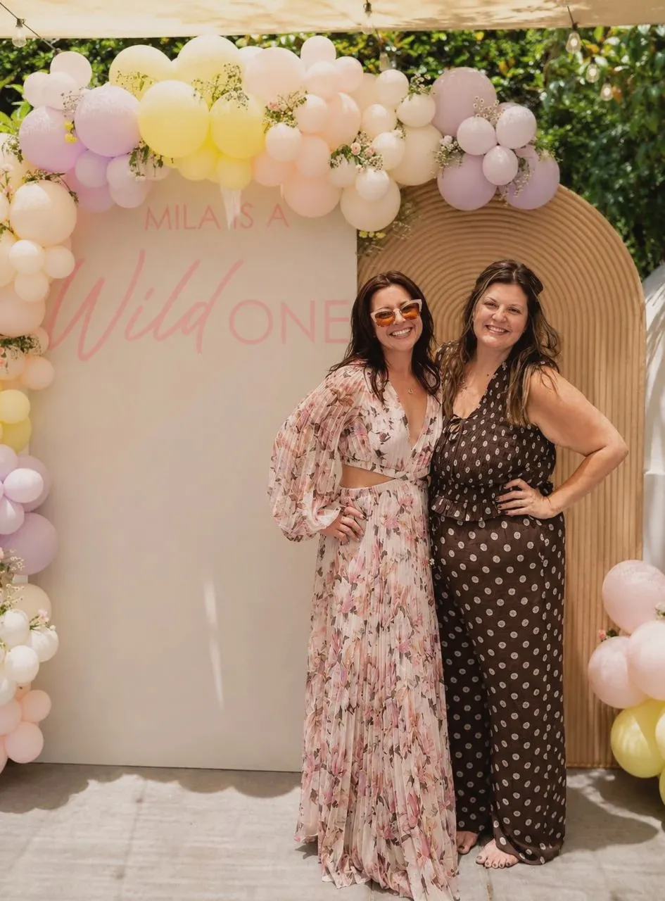 Ruta and Francie, co-founders of Bubbly SoCal, in front of a balloon arch at one of their celebrations