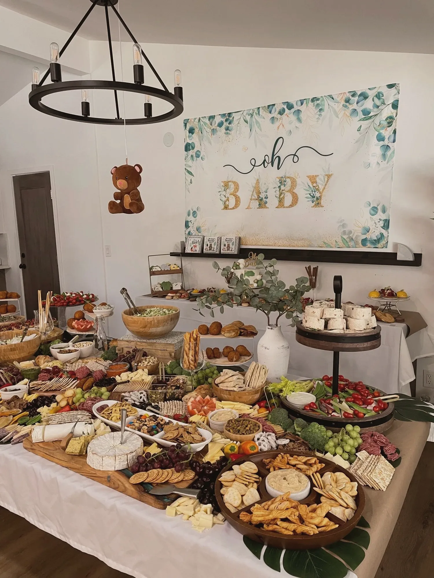 The grazing table from another angle with the Oh Baby backdrop and a hanging teddy bear above it